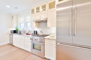 Modern kitchen with high-end stainless steel appliances, sleek cabinetry, and ample counter space for cooking and entertaining.