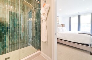Luxurious bathroom with a glass-enclosed shower, elegant tile work, and premium fixtures for a spa-like experience.