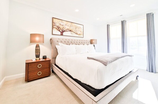Elegant bedroom with a plush bed, soft lighting, and modern decor for a restful and luxurious stay.