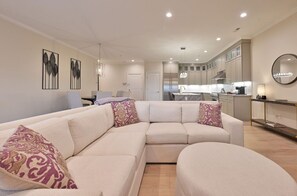 Spacious and stylish living area with a large sectional sofa, perfect for relaxing and socializing with family and friends.