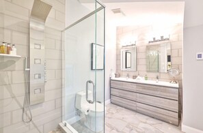 Luxurious bathroom with a spacious walk-in shower and modern amenities. A spa-like retreat for your stay.