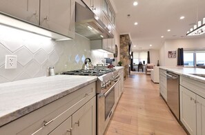 Modern kitchen with sleek cabinetry, high-end appliances, and a spacious layout perfect for culinary enthusiasts.