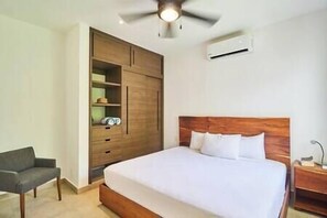 Comfort and productivity await in our bedroom with a wardrobe and towels.