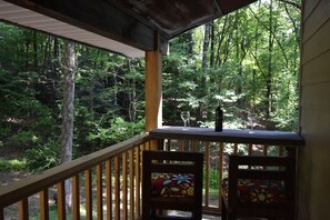 Off side deck overlooking forest. 