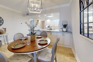 The dining area comfortably seats four plus two more at the kitchen bar area and is perfect for enjoying meals with a view of the ocean