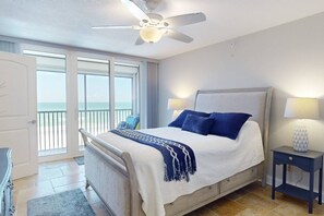 Primary Bedroom: Enjoy a restful night’s sleep on a plush queen-sized bed with sweeping Gulf views