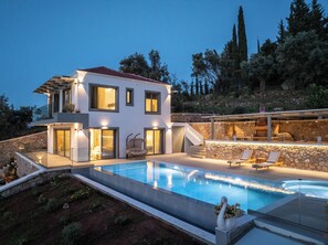 Outdoor swimming pool area with jacuzzi and barbeque offering amazing sea views