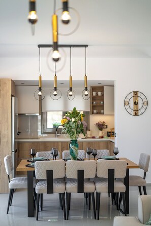 Open plan fully equipped kitchen - living area with direct access to the pool.