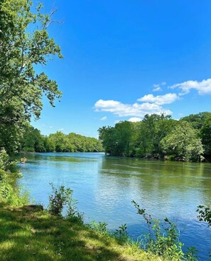 Unwind in our spacious backyard with a patio, fire pit, hot tub, grill, and stunning views of the South Fork Shenandoah River.