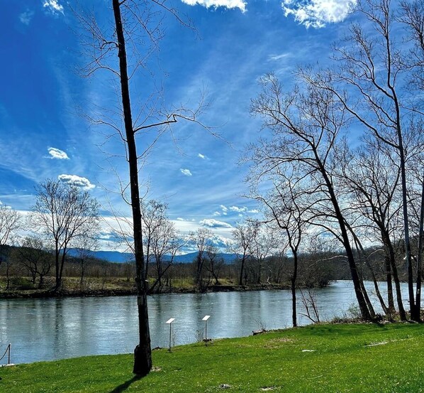 Unwind in our spacious backyard with a patio, fire pit, hot tub, grill, and stunning views of the South Fork Shenandoah River.