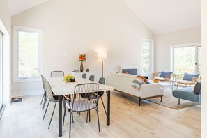 Open plan of living room and dining room with lots of natural lighting