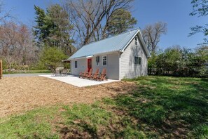 The front door has a patio and some seating options for guests.