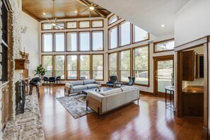 This living room is here to make a statement! With floor-to-ceiling windows, you can bask in the warm glow of sunlight and enjoy the backyard pool views