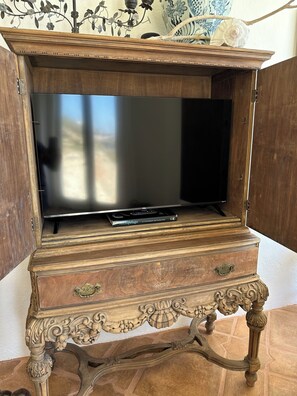 rokutv inside the antique cabinet w/ a pullout swivel shelf for optimum viewing 