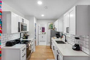 This modern, all-white kitchen provides the perfect backdrop for all your culinary adventures.