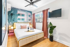 The bed is adorned with high-quality linens, including a soft, downy duvet and an array of pillows in varying degrees of firmness, ensuring a perfect night’s sleep.