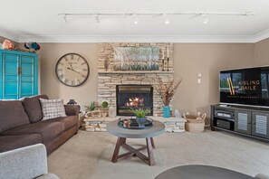 Upstairs living room with a gas fireplace, cable TV & sound system