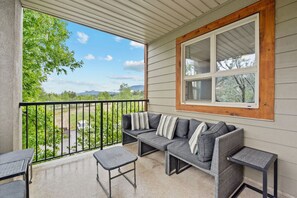 Private patio with outdoor seating, a BBQ & mountain views