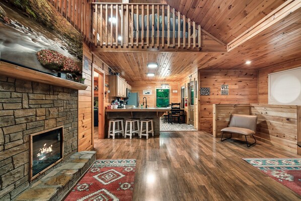 Cozy living room, with fireplace opens to the kitchen and dining areas.