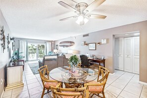 Bright dining area with a glass-top table and seating for four