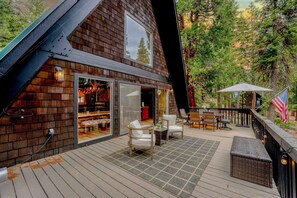Exterior: Upper deck, outdoor dining table, umbrella, outdoor chairs
