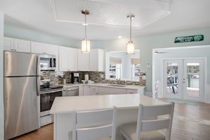 Renovated chef's kitchen with island and breakfast bar