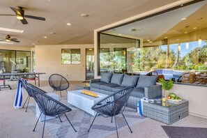 Enjoy outdoor living featuring a firepit table, comfortable seating, ping pong table, and more!