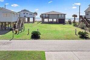 View from upper deck.  Within a few minutes you can have your toes in the sand! The road shown is a neighborhood road, not the main highway.  This home is beachside! No crossing a busy highway.