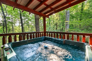 Hot tub with beautiful view from covered deck.
