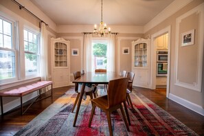 Formal dining room with booster chairs, table with extension, and seating up to 8