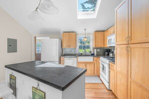 Beautiful fully-equipped kitchen with a skylight and all the appliances & utensils you could need to enjoy a home cooked meal.