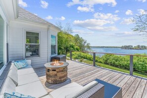 Enjoy happy hour on this back patio with a firepit, two grills, a hot tub, and stunning sunset views.