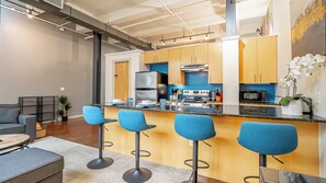 Cook and entertain in a sleek, fully-equipped kitchen featuring modern appliances, ample counter space, and all the essentials for a seamless dining experience in the heart of Fort Worth.