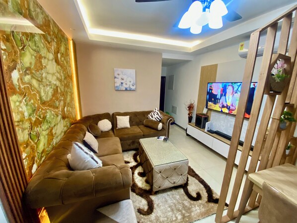 Living room with 55” HD smart TV to keep you entertained 