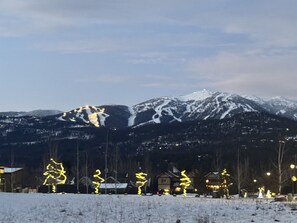 A clear, crisp night on Whitefish Mountain, with the slopes bathed in the soft glow of snow-covered peaks.
