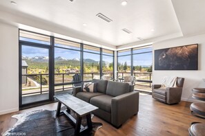 Expansive windows invite natural light and majestic mountain vistas! Enjoy every moment.