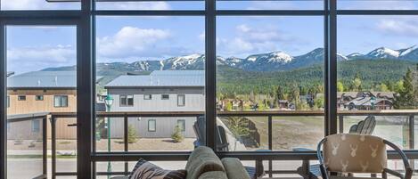 Dramatic mountain views through floor-to-ceiling windows invite relaxation and adventure!