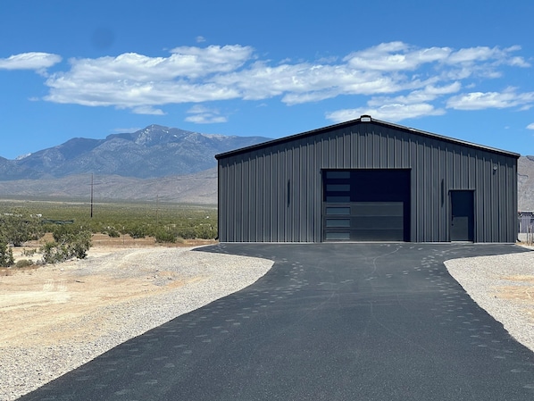 Pavement to Barndominium, garage in front, house in back.