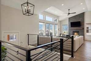 Ascend to the living room from the entrance below and be awed by the vaulted ceilings, spectacular views, and contemporary, inviting design.