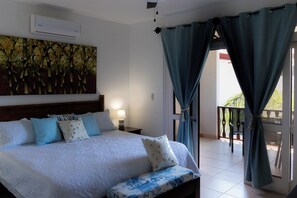 Spacious master bedroom with balcony access for a breezy, tranquil retreat.