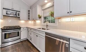 Kitchen wil Toaster, Nespresso, Diswasher, Oven, and cooking utensils