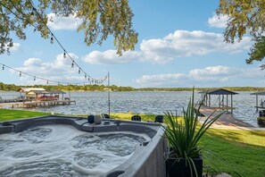 Unwind in the bubbling hot tub while taking in the view of the lake