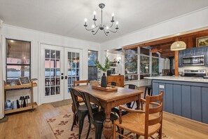 spacious dining area with table that seats 8-10 when expanded and three barstools in the kitchen
