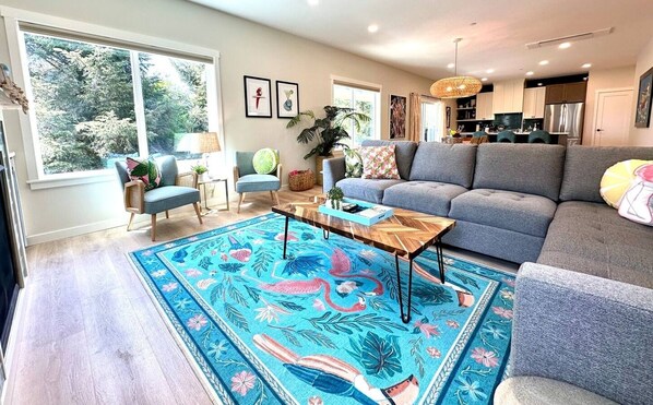 Spacious open-concept living room, ideal for sharing stories, playing games, or enjoying movie nights.