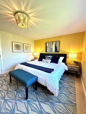 Large ensuite bedroom with king bed, smart TV, and beautiful canal view.
