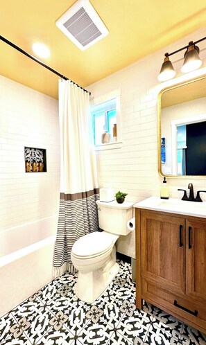 Spa like bathroom with heated tile floors, linens and toiletries.