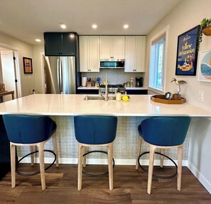Pull up a stool and chat while the chef enjoys this gourmet kitchen.
