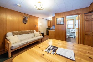 Comfortable futon, log wood dining table, northern michigan themed decor.