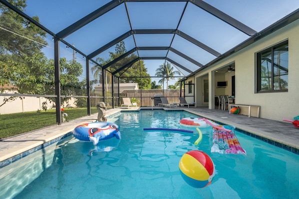 Enjoy our screened-in heated pool, comes fully equipped with floats and toys