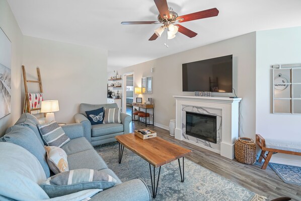 Cozy living room with electric fireplace and pullout sleeper sofa.